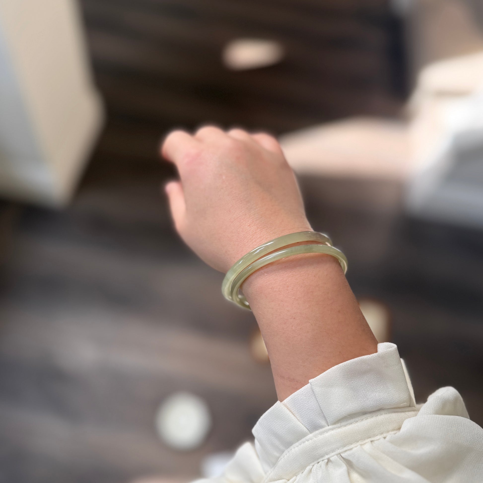 Natural White Jade showcasing unique black inclusions and delicate cotton-like textures—each piece naturally one of a kind.