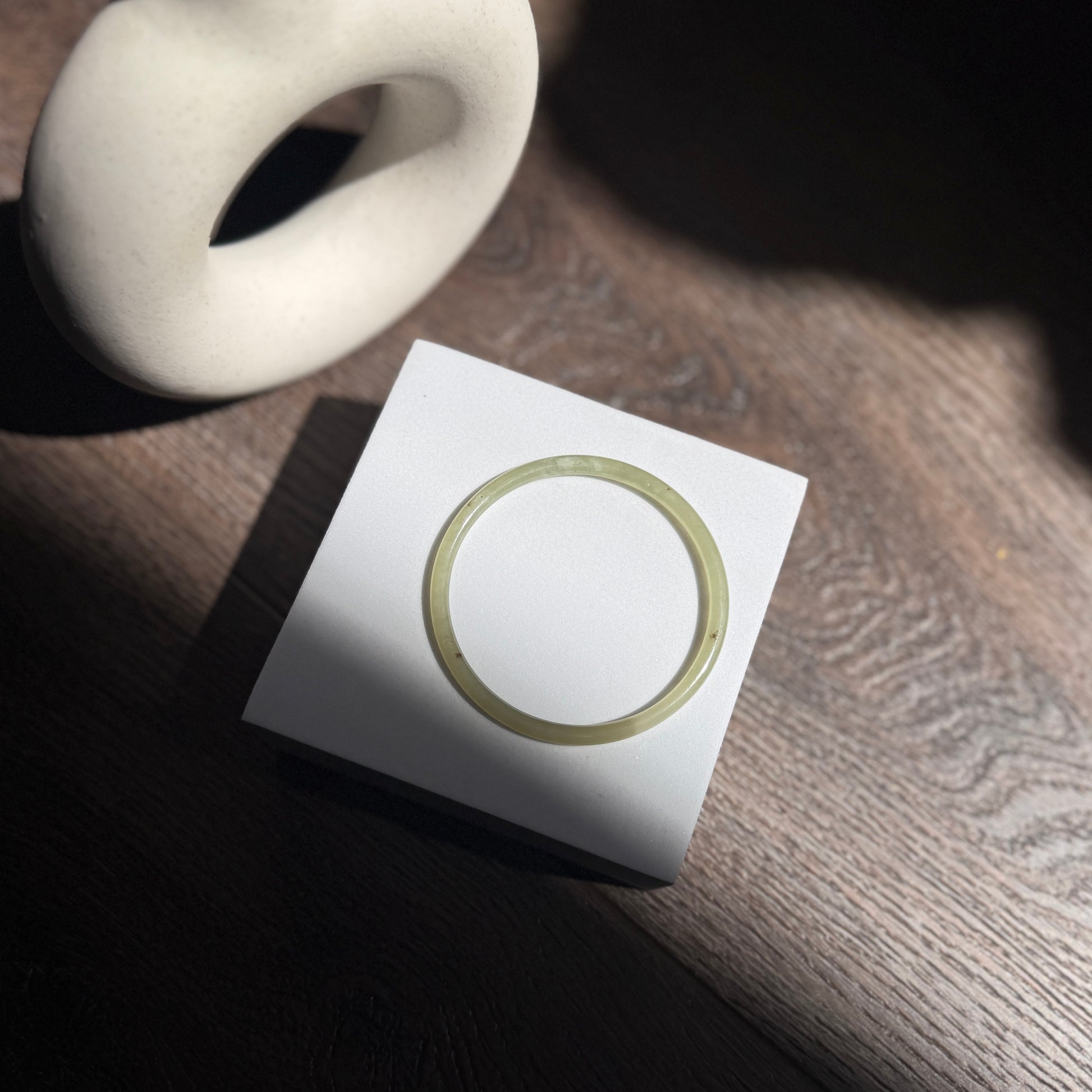 Natural White Jade showcasing unique black inclusions and delicate cotton-like textures—each piece naturally one of a kind.